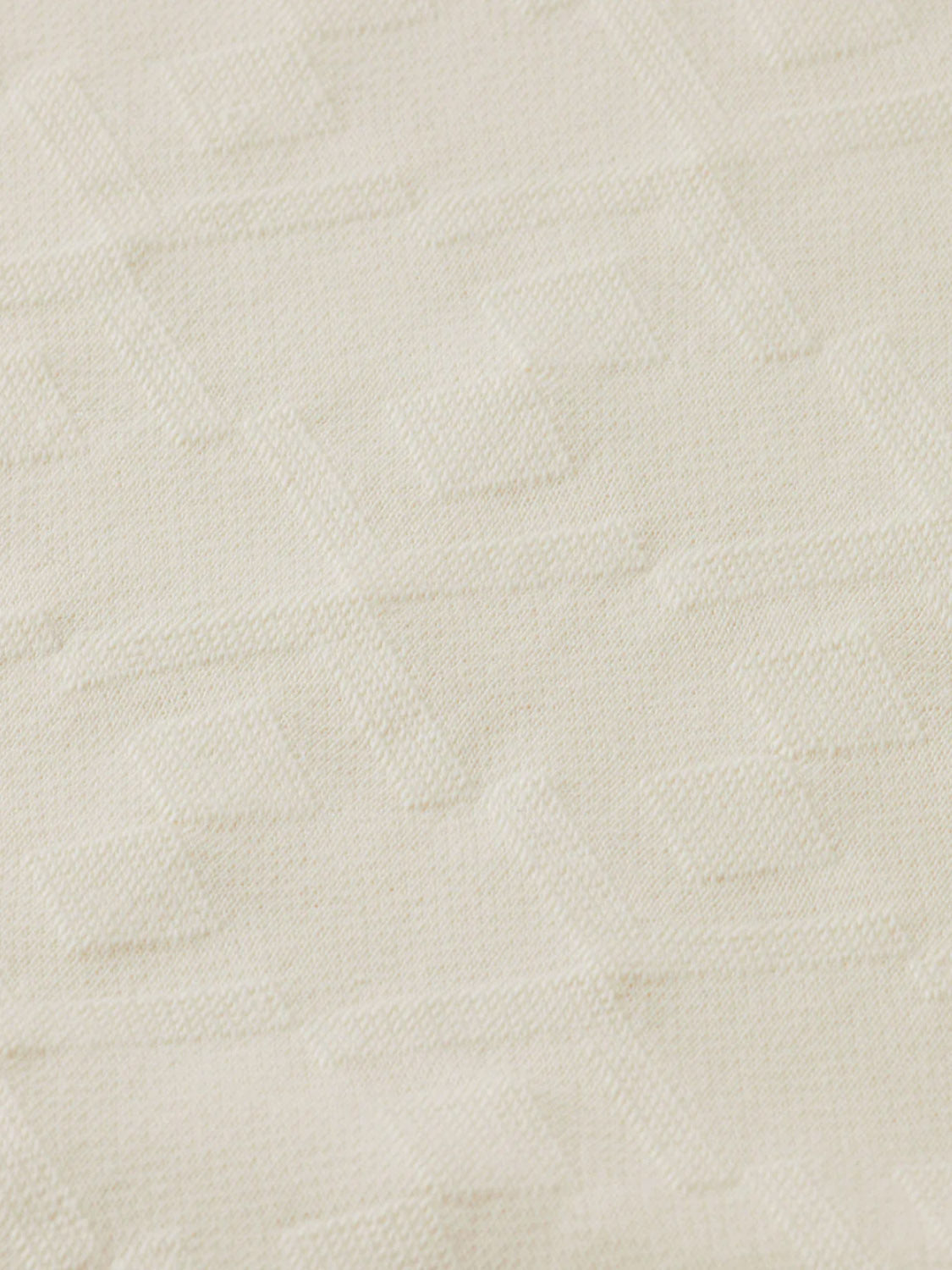 Close-up of 181532 - Jacquard Terry Sweatshirt by Scotch & Soda, featuring cream-colored jacquard fabric with a subtle geometric pattern and raised interlocking shapes for a textured, sophisticated look.