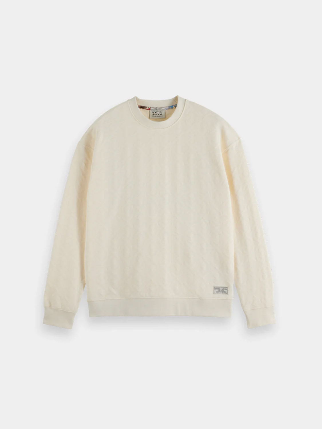 The Scotch & Soda 181532 Jacquard Terry Sweatshirt is a casual off-white crewneck with long sleeves, ribbed cuffs and hem, plus a small rectangular tag by the bottom left hem, shown on a white background.