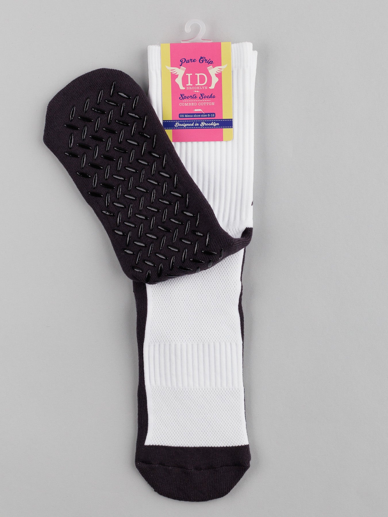 White ID Menswear Grip Sports Socks featuring premium grip technology with black soles for optimal performance and comfort. The packaging showcases a pink and purple label against a gray background.
