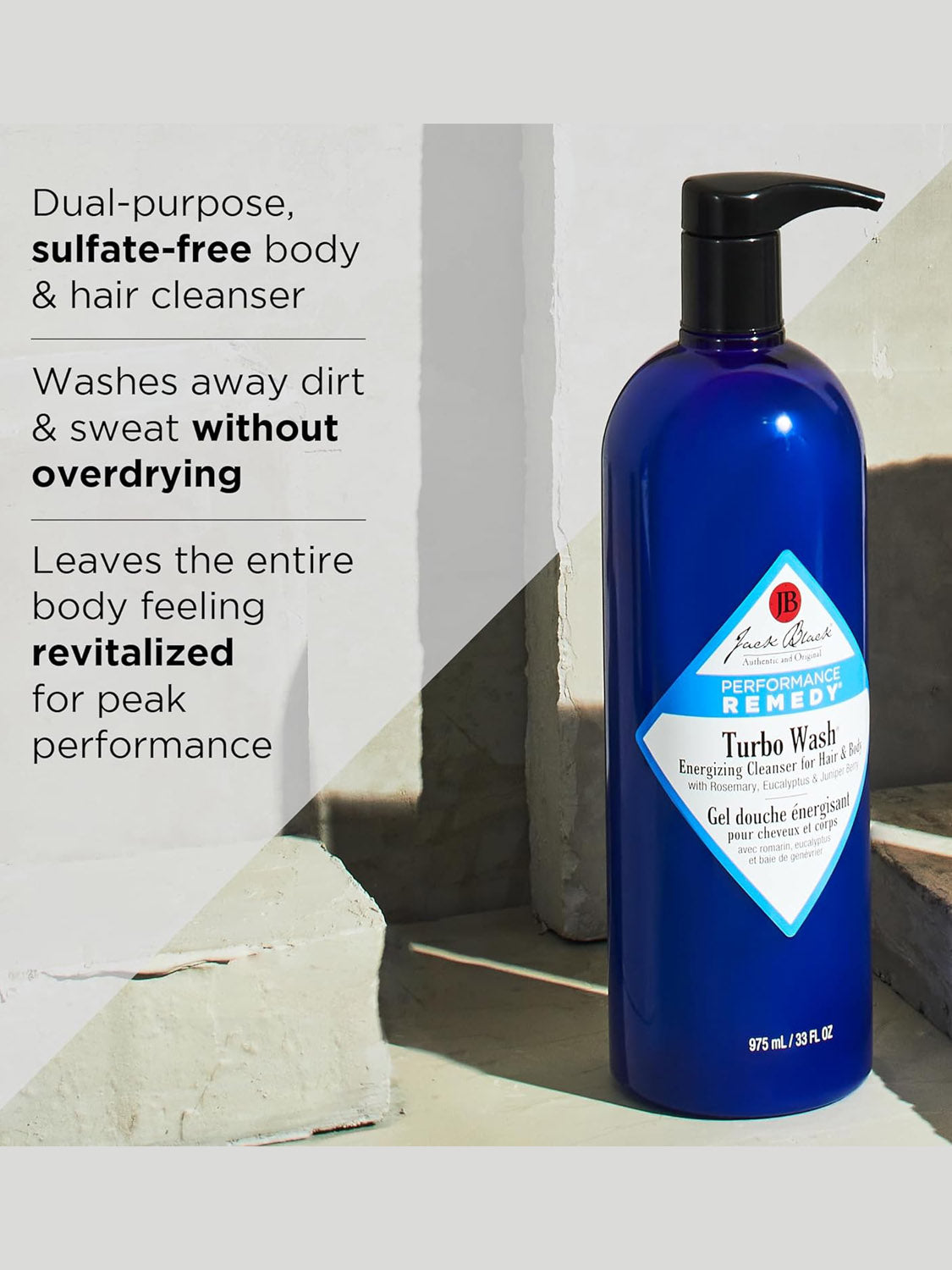 A blue bottle of Jack Black Body and Hair Cleanser sits on tiles. Rosemary and eucalyptus are featured for a revitalizing, sulfate-free formula that gently cleanses and moisturizes without drying skin or hair.