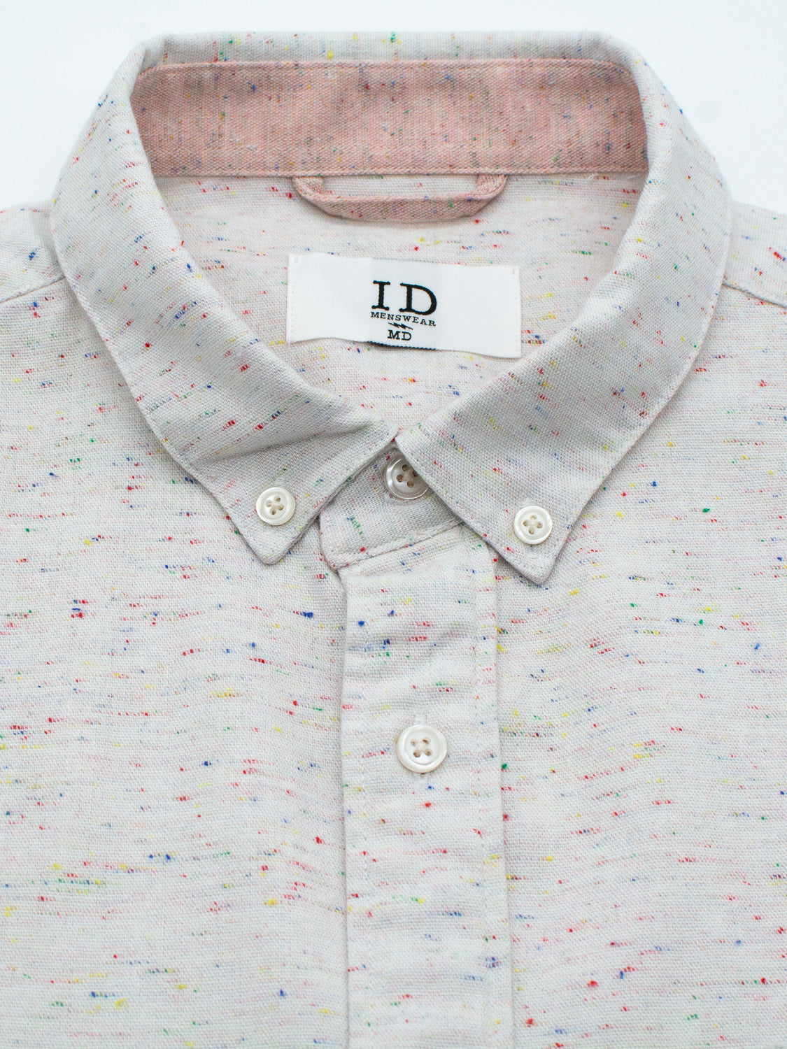 The Allswell Speckled Button Down Shirt by ID Menswear in a light gray cotton-linen blend features a multicolored speckled pattern. With its neatly folded collar and two visible buttons, this versatile shirt suits any occasion.