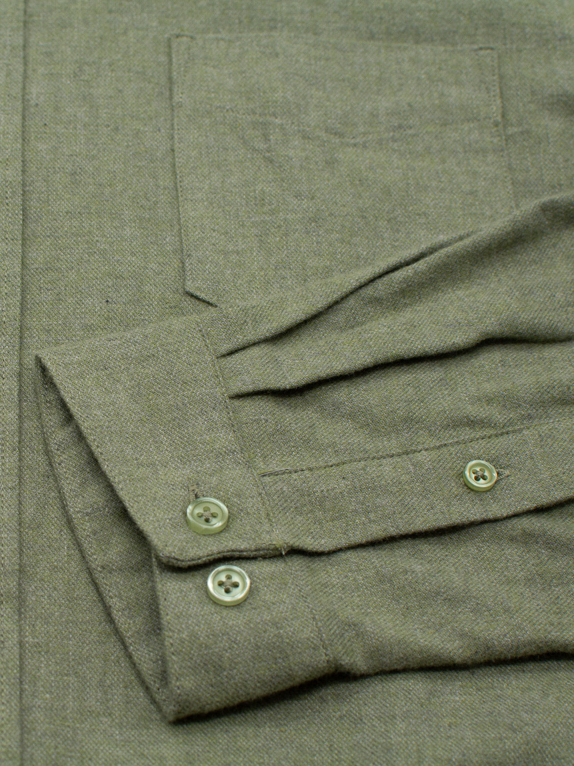 The Max Brushed Flannel Shirt by ID Menswear is a timeless olive green wardrobe essential featuring visible pocket and sleeve details. Its folded cuff with two green buttons highlights the textured, woven 100% cotton fabric that exudes classic charm.