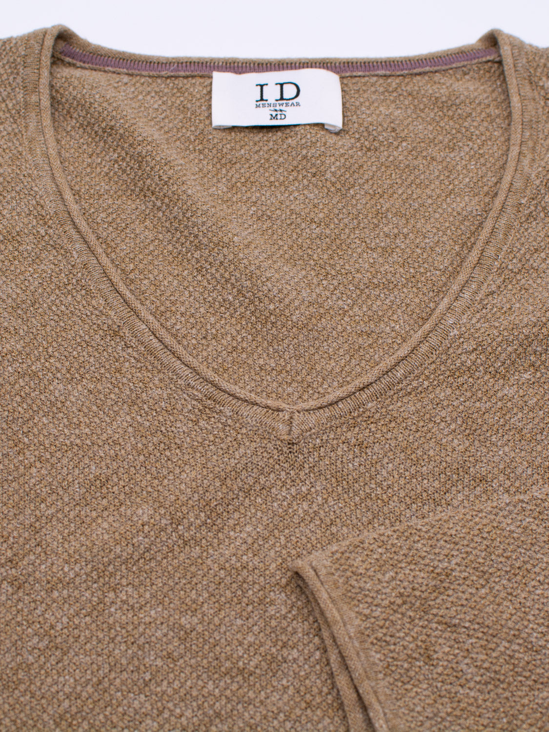 A brown Amalfi Deep V Knitted Top by ID Menswear, shown flat, features a textured knit pattern. A tag inside the collar reads ID and MD. Made from a linen-cotton blend, it offers a soft look with a subtle finish.