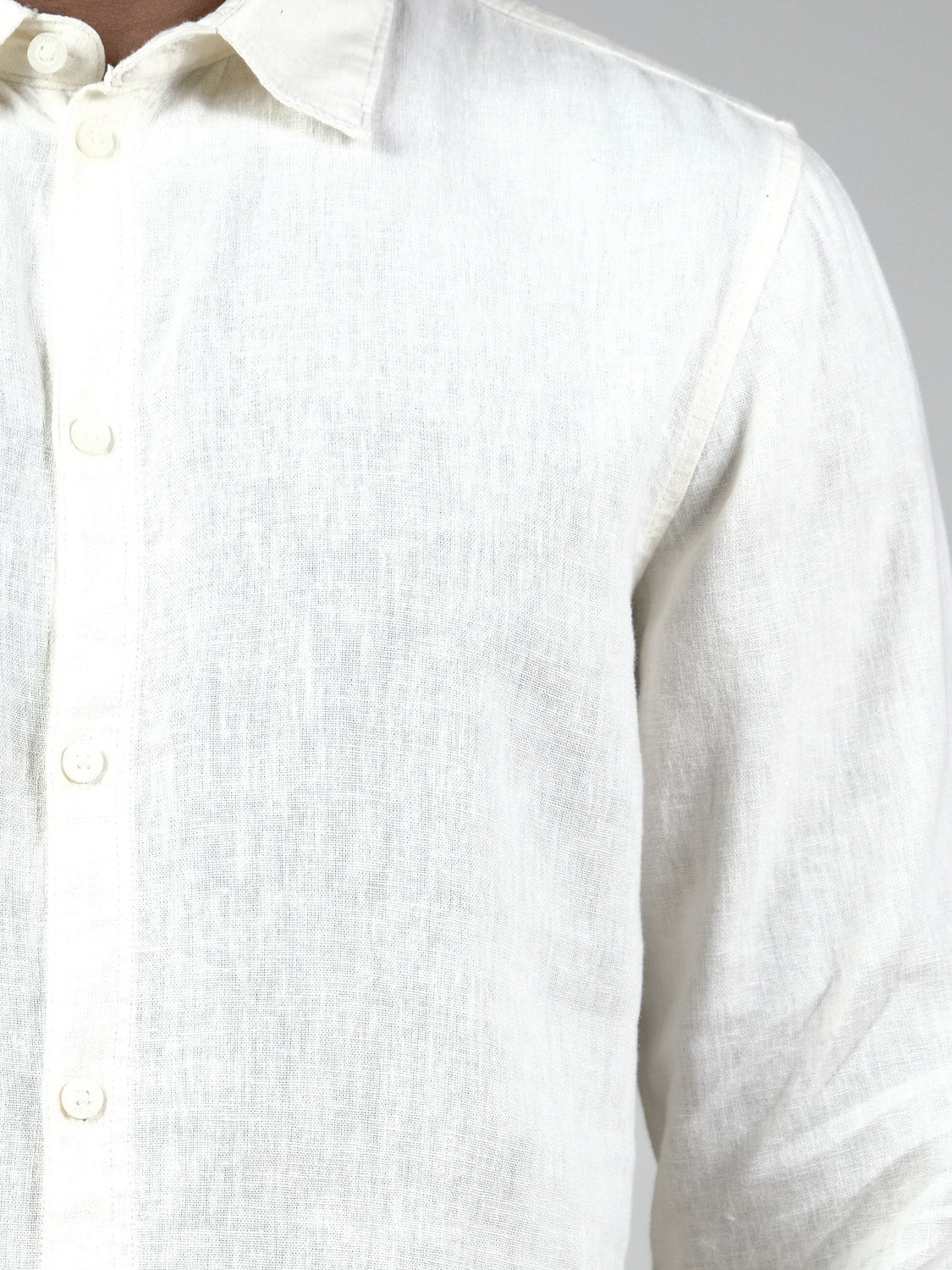 A close-up of the Enea Allan Long Sleeve Shirt by !Solid, a breathable men’s white linen shirt with button-up front; only the shirt and part of the neck are shown against a plain background.