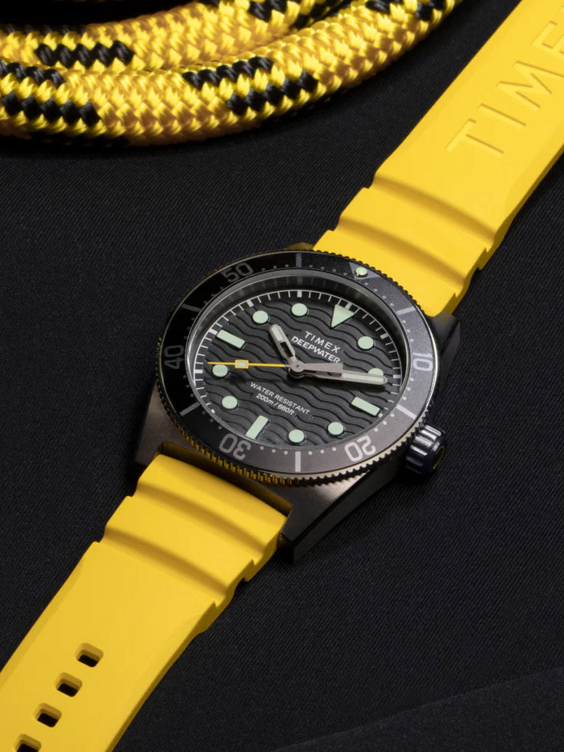 The Timex Deepwater Reef 200 is a 41mm wristwatch featuring a distinctive black and yellow design, Super-Luminova® for enhanced visibility, and a bold yellow synthetic rubber strap with a black bezel. Ideal for underwater adventures, a textured surface complements its luminous markers.