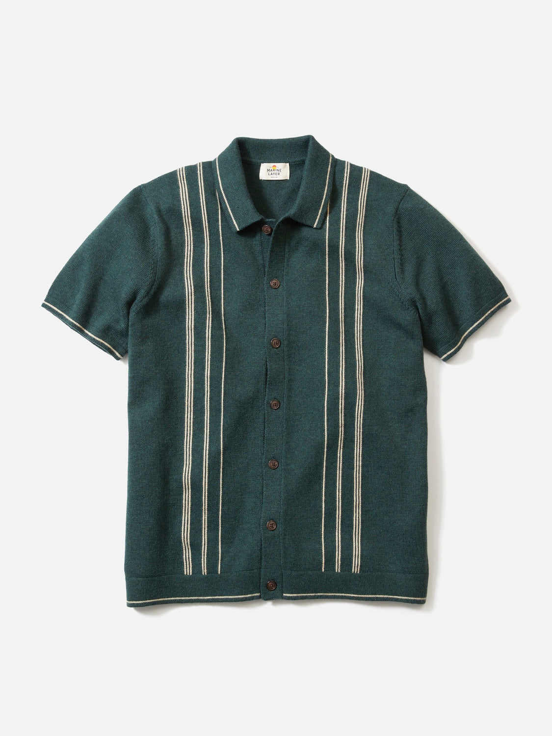 The Barry Sweater Button Down by Marine Layer is a dark green, short-sleeve, collared shirt with vertical white stripes, dark center buttons, and a classic fit. It’s made from a cotton nylon wool blend for a retro-inspired look.