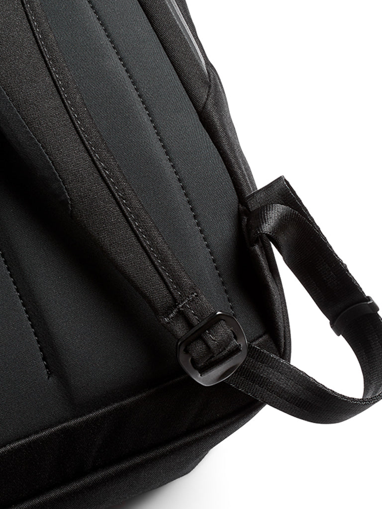 Close-up of the Melbourne Backpack 18L by Bellroy shows its padded shoulder strap with an adjustment buckle and stitched detailing, set against a white background.