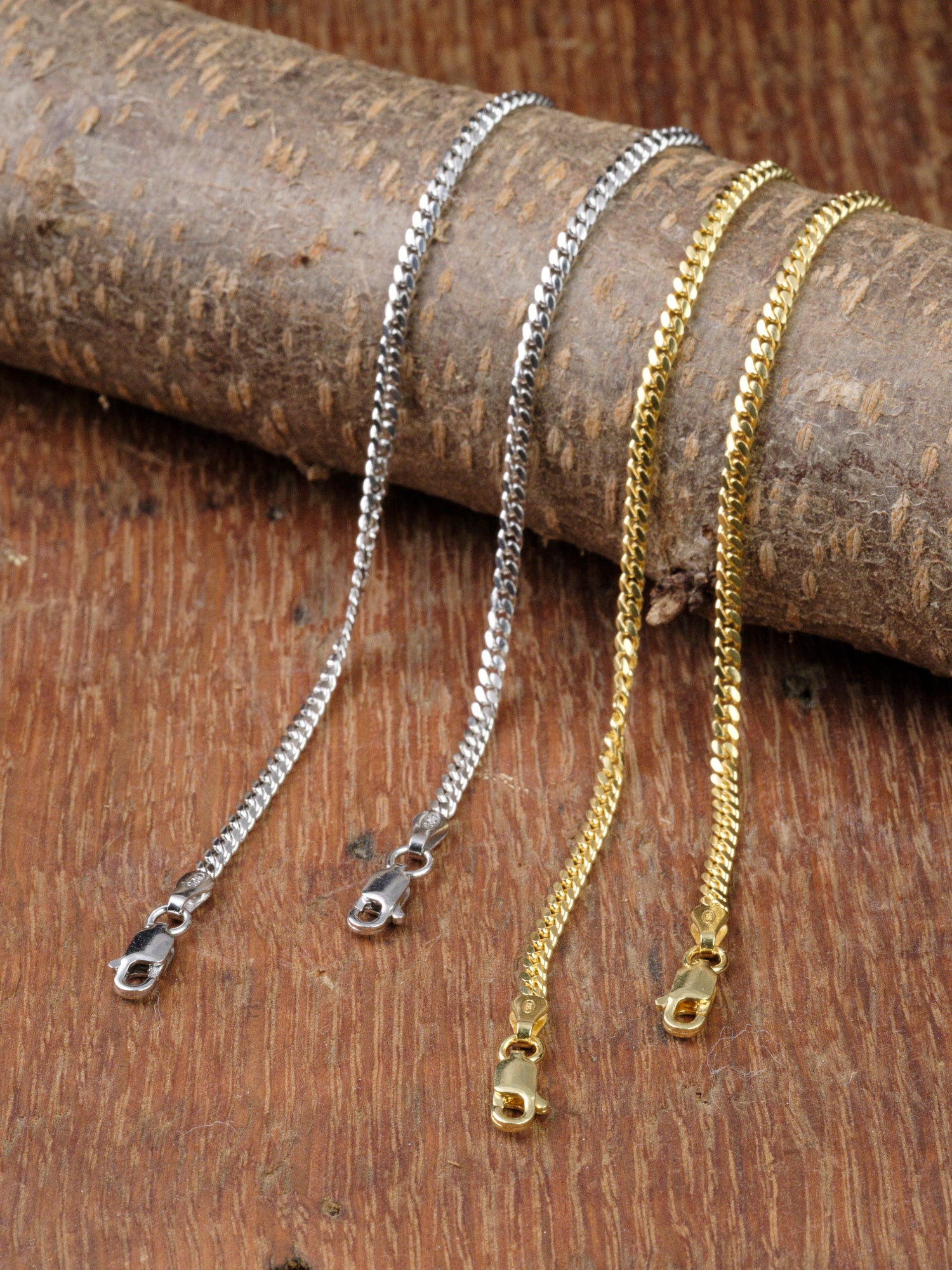 The Blaze 80 Miami Cuban Bracelet by ID Menswear is displayed on textured brown wood, featuring a secure lobster clasp for easy wear.