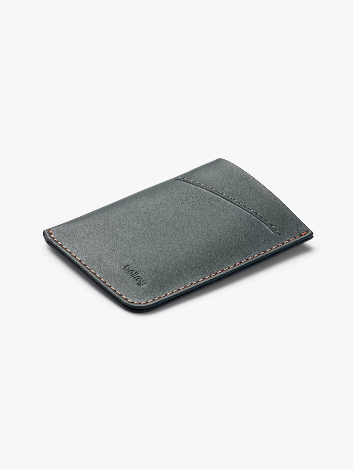 The Bellroy Card Sleeve Wallet, crafted in dark green leather with subtle edge stitching and a single card slot, is displayed on a light gray background.