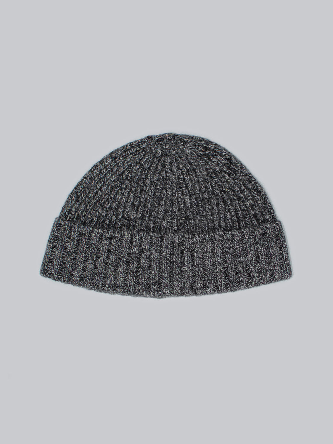This ID Menswear Cho Oyu Merino Wool Fishermans Beanie is a gray knit winter accessory featuring a ribbed pattern and folded brim, showcased on a light gray background.
