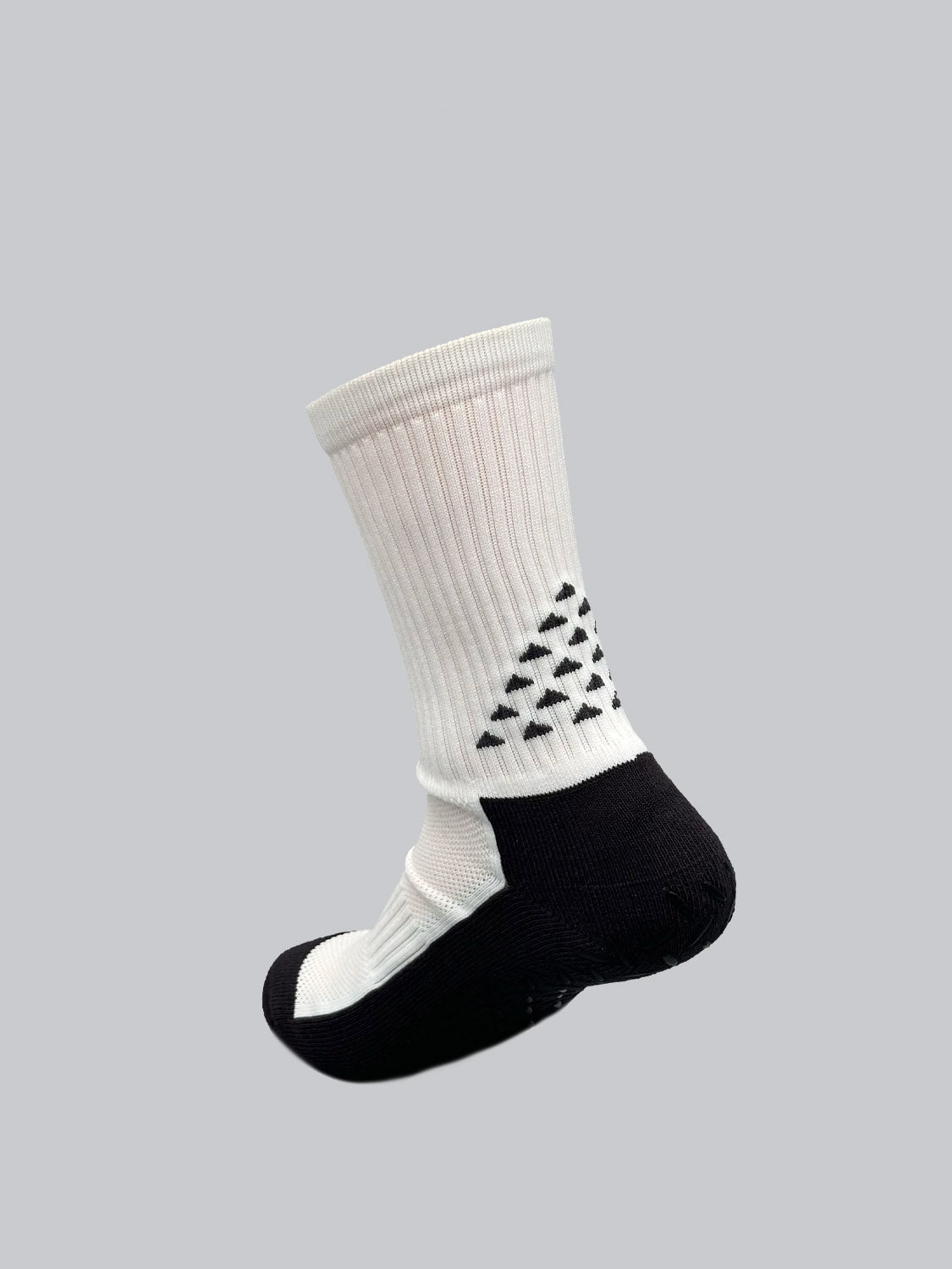 ID Menswears Grip Sports Socks feature a black sole and heel on a white, mid-calf silhouette, adorned with a triangle pattern. The anti-slip design ensures stability and comfort, complemented by a solid light gray backdrop for a modern look.