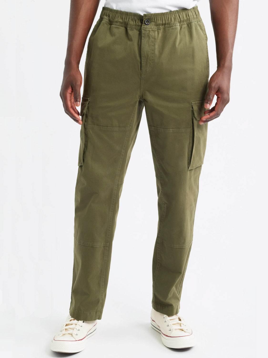 A person models the Rails Jaiden Cargo Pants in olive green with white sneakers, standing against a plain white background and hands at their sides.