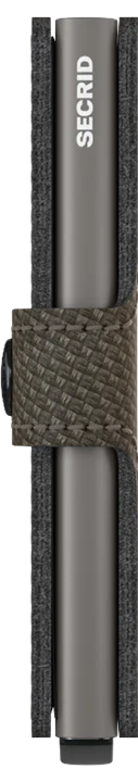 A close-up of the Secrid Miniwallet Carbon Weave Pattern Leather with RFID protection, showcasing a textured, dark weave strap holding two metallic grey card holders, displayed vertically against a light background.