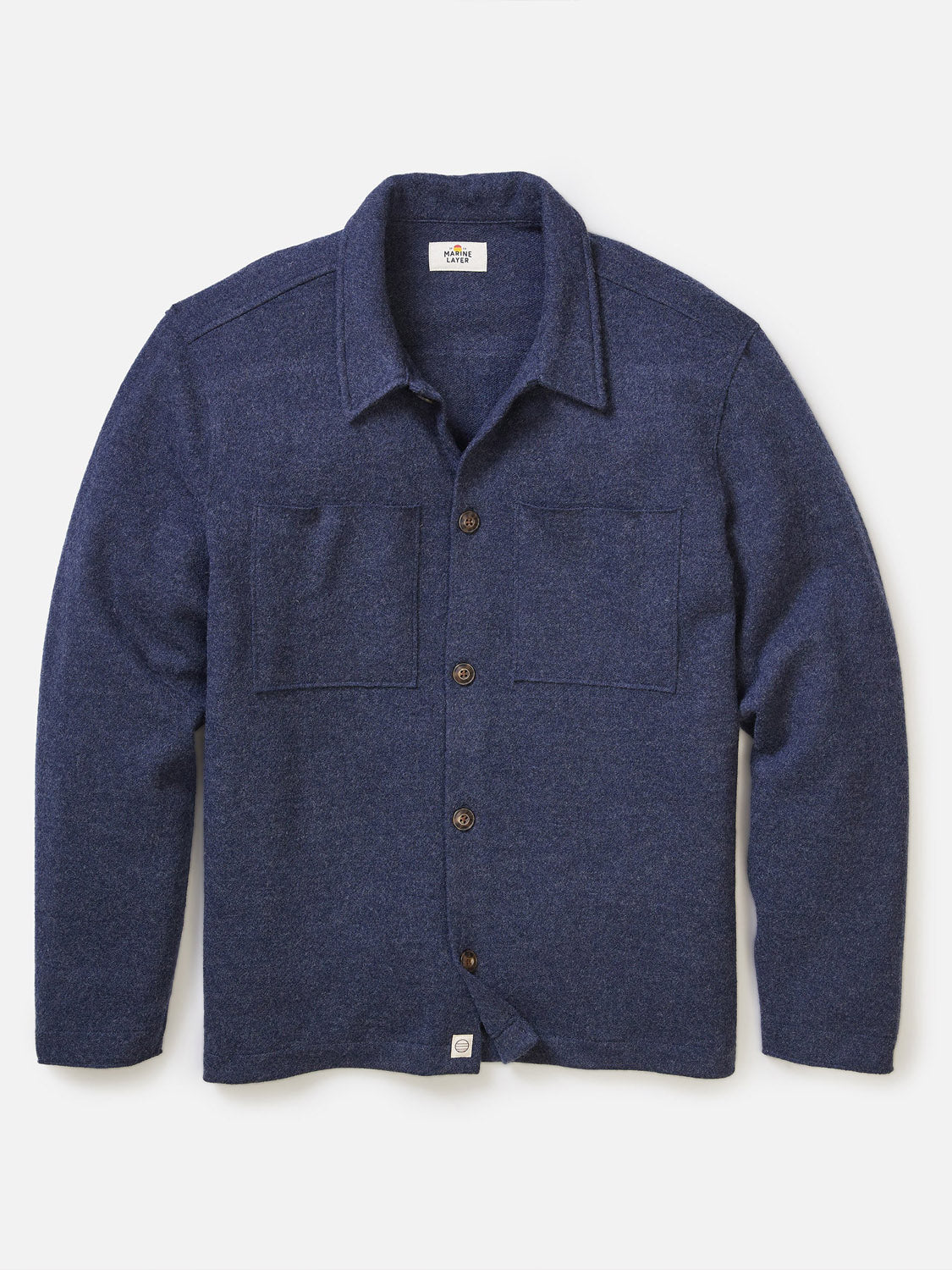 The Marine Layer Mendocino Wool Overshirt in deep navy blue features long sleeves, a button-up front, two large chest pockets, and a classic collar, shown laid flat on a white background.