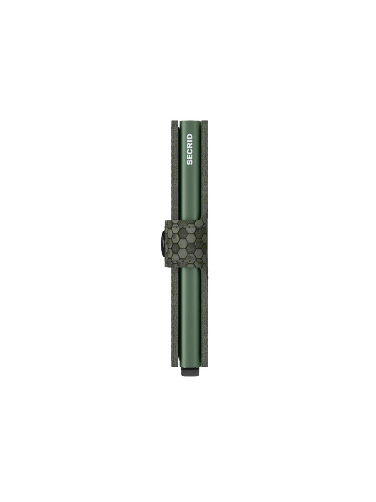 A green pen labeled SCRIB stands in a matching green, hexagon-patterned holder beside a Secrid Miniwallet Hexagon—both displayed vertically against a plain white background.