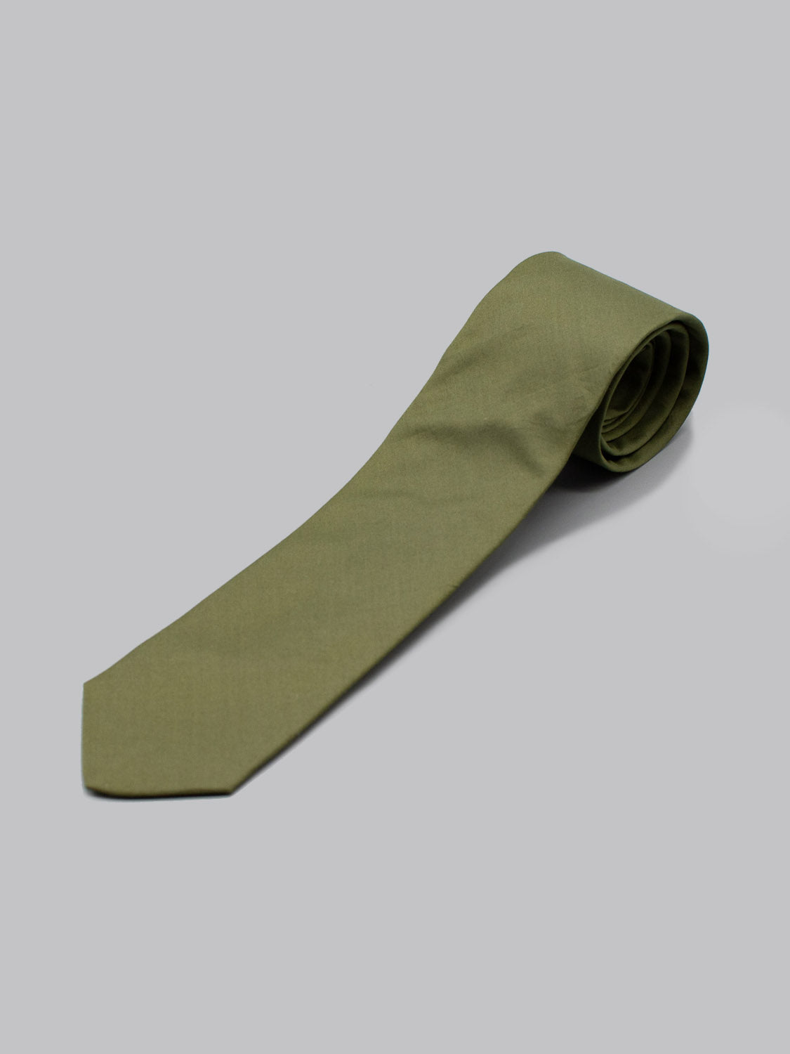 The Liberty of London Tana Lawn™ Moss Tie by ID Menswear, handmade in Brooklyn, is shown neatly rolled on a plain light gray background.