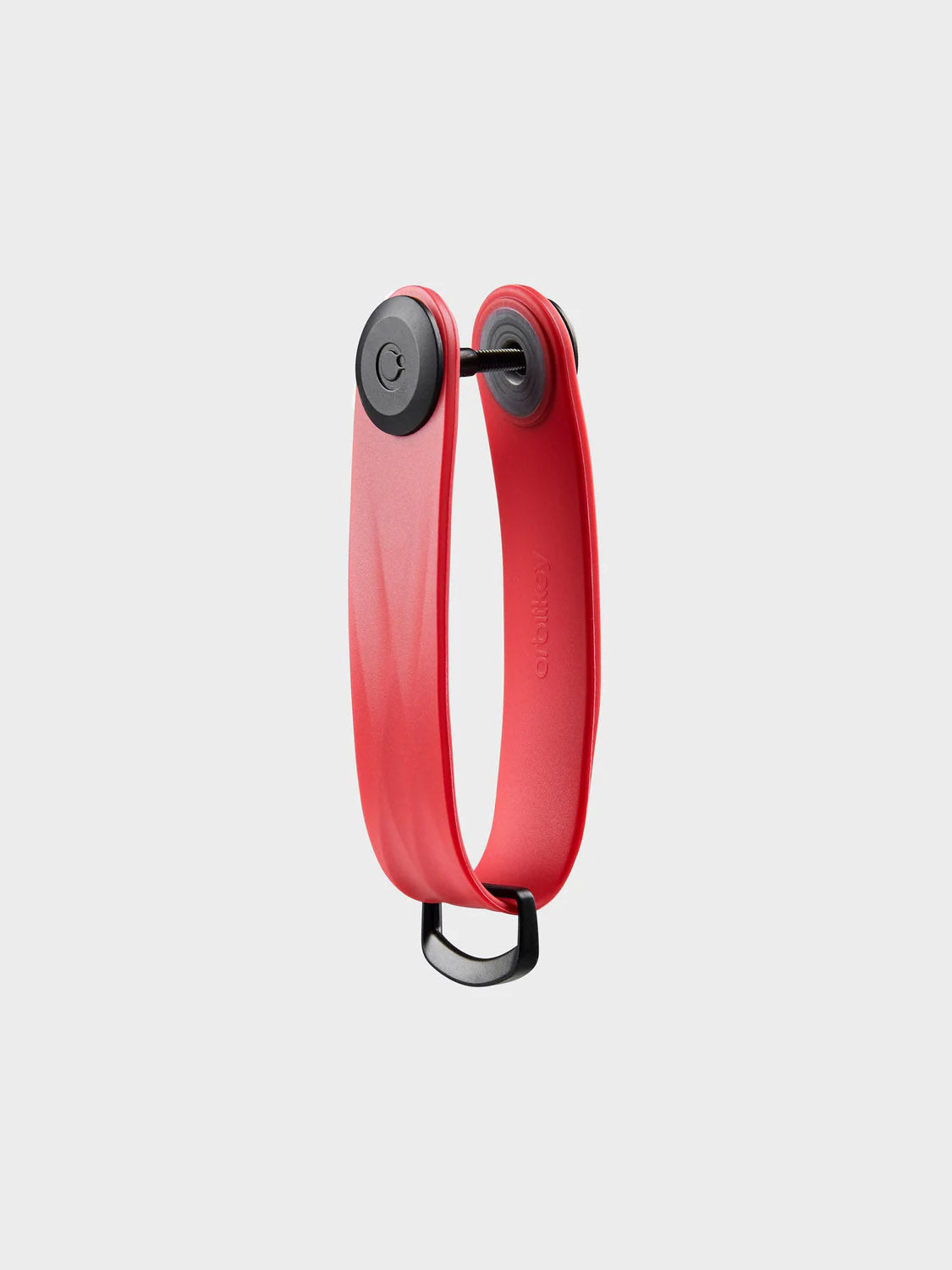 The Orbitkeys Key Organizer Rubber Active features a slim, curved red and black design with two black circular ends, neatly stacking keys in silence. It stands upright on a plain white background.