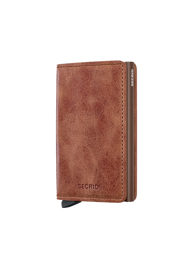 The Secrid Slimwallet Vintage Leather by Secrid is a brown wallet with a textured finish, RFID/NFC security, metal edge, and black lever at the base, displayed on a white background.
