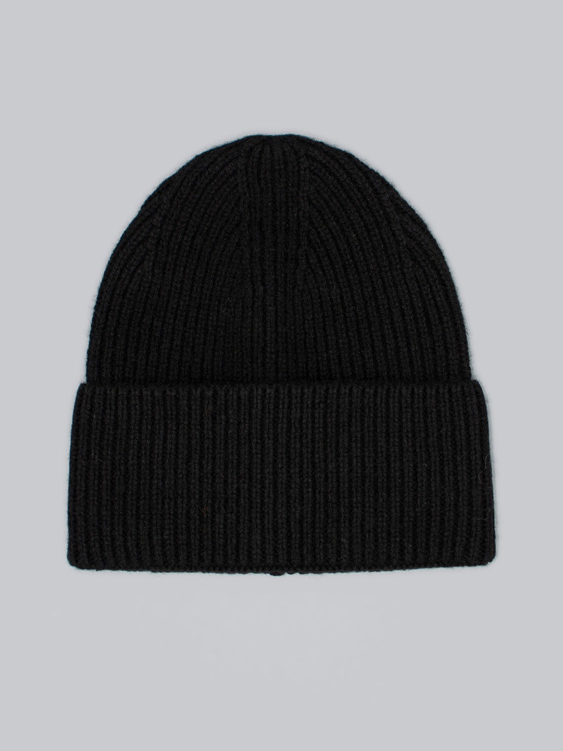 The Telluride Wool Beanie by ID Menswear is a black ribbed wool hat providing natural insulation and a comfortable fit, shown flat on a plain grey background.