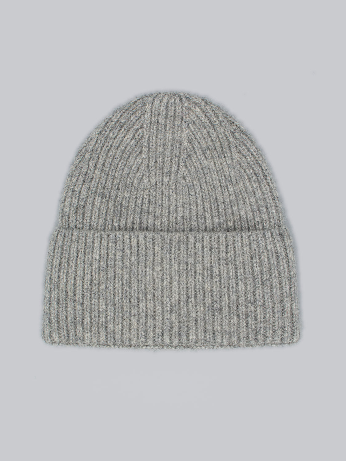 The Telluride Wool Beanie by ID Menswear, featuring a gray ribbed design, provides natural insulation and rests on a light gray backdrop.