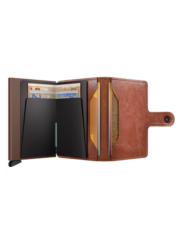 The Secrid Miniwallet Vintage Leather is open, displaying cards, euro banknotes, and organized compartments. It features RFID protection and a secure snap-button closure on the right side.