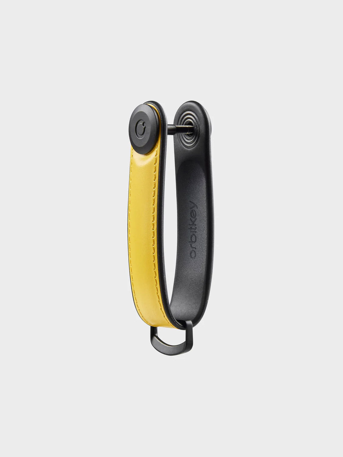 The Orbitkeys Key Organizer Hybrid Leather features a compact yellow Nappa leather holder with black hardware, embossed branding, and a secure locking mechanism, keeping multiple keys organized in style.