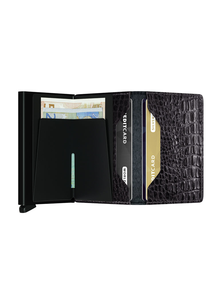 The Secrid Slimwallet Nile in black crocodile-pattern leather is shown open, with euro notes, two credit cards, and an ID card neatly arranged in its compartments.