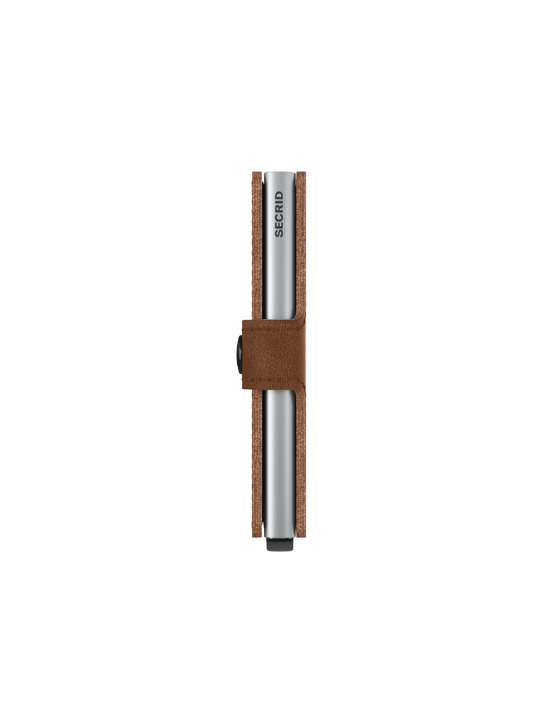 A slim, silver SECRID cardholder is encased in a Secrid Miniwallet Vintage Leather cover in brown, featuring a button clasp, shown from the side with the clasp facing forward against a white background.