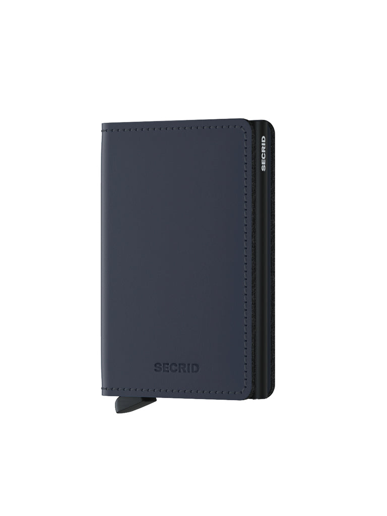 A closed Secrid Slimwallet Matte Finished Leather, featuring a minimalist design with rounded edges and embossed logo, stands upright on a white background. This RFID wallet provides sleek protection in a slim, matte leather form.