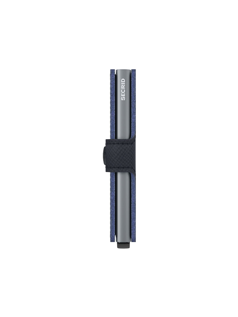 The Secrid Miniwallet Saffiano Leather, in blue and black with a visible metal component and built-in RFID protection, is shown closed from the side against a white background.