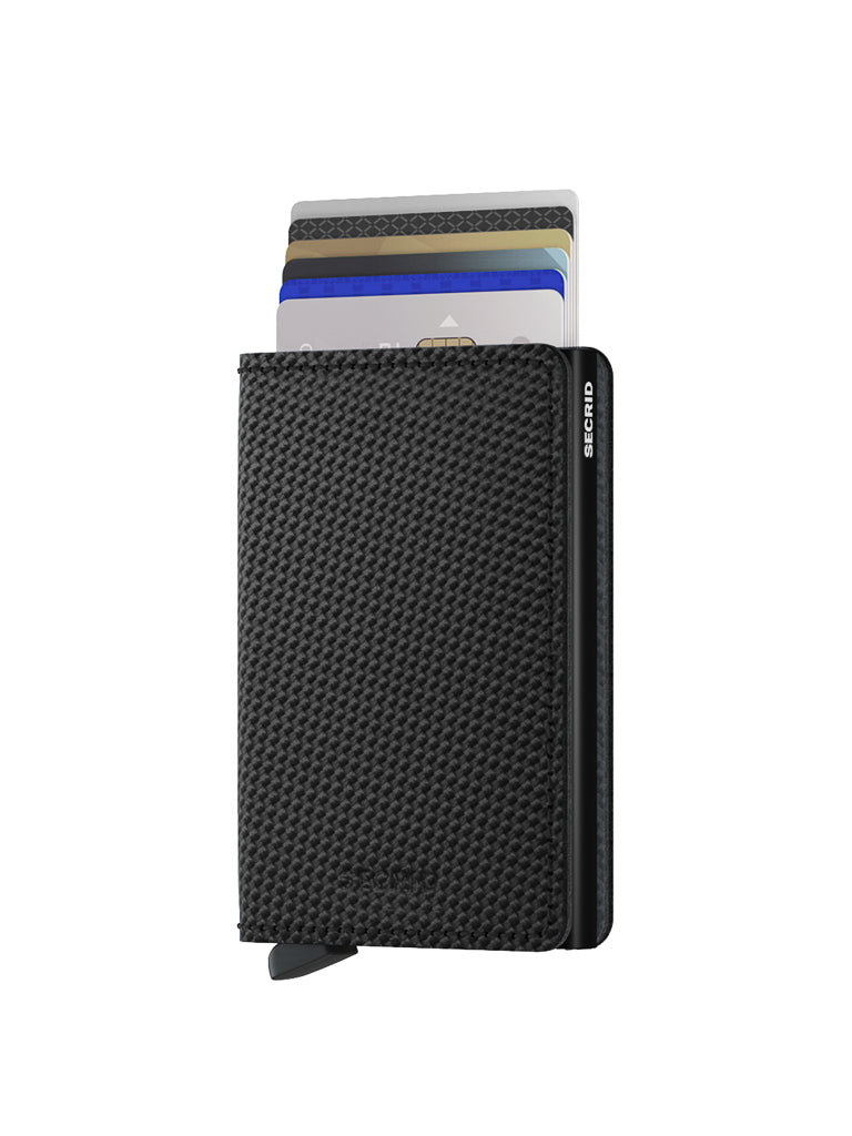 A black carbon fibre pattern Slimwallet from Secrid, featuring vertically inserted credit cards and set against a white background. This slim leather wallet offers RFID protection, with the Secrid brand name visible on the side.