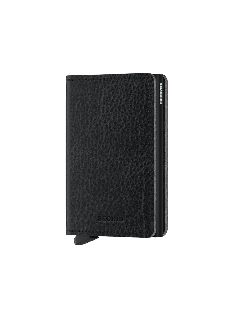 The Secrid Slimwallet Vegetable Tanned Leather is a slim black wallet with a textured finish, featuring the Secrid logo on the front and metal side, and offers built-in RFID protection.