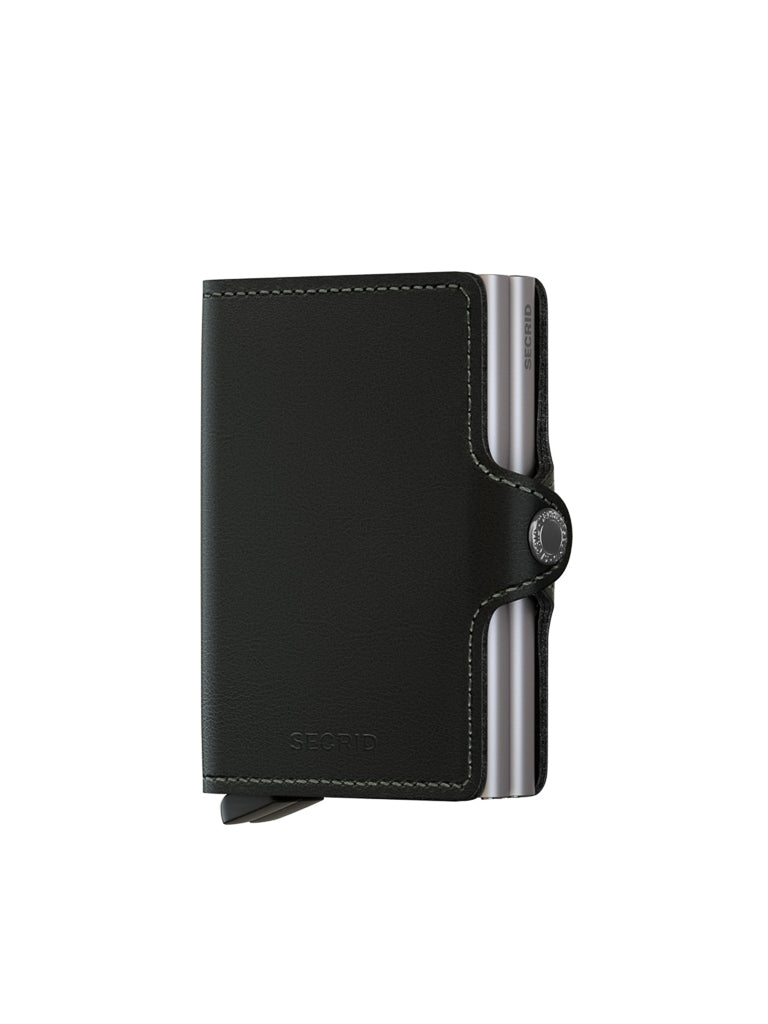 The Secrid Twin Wallet Original Compact, a sleek black leather wallet with white stitching and a right-side snap button, is shown partially open to reveal metal card edges—stylishly displayed against a white background.