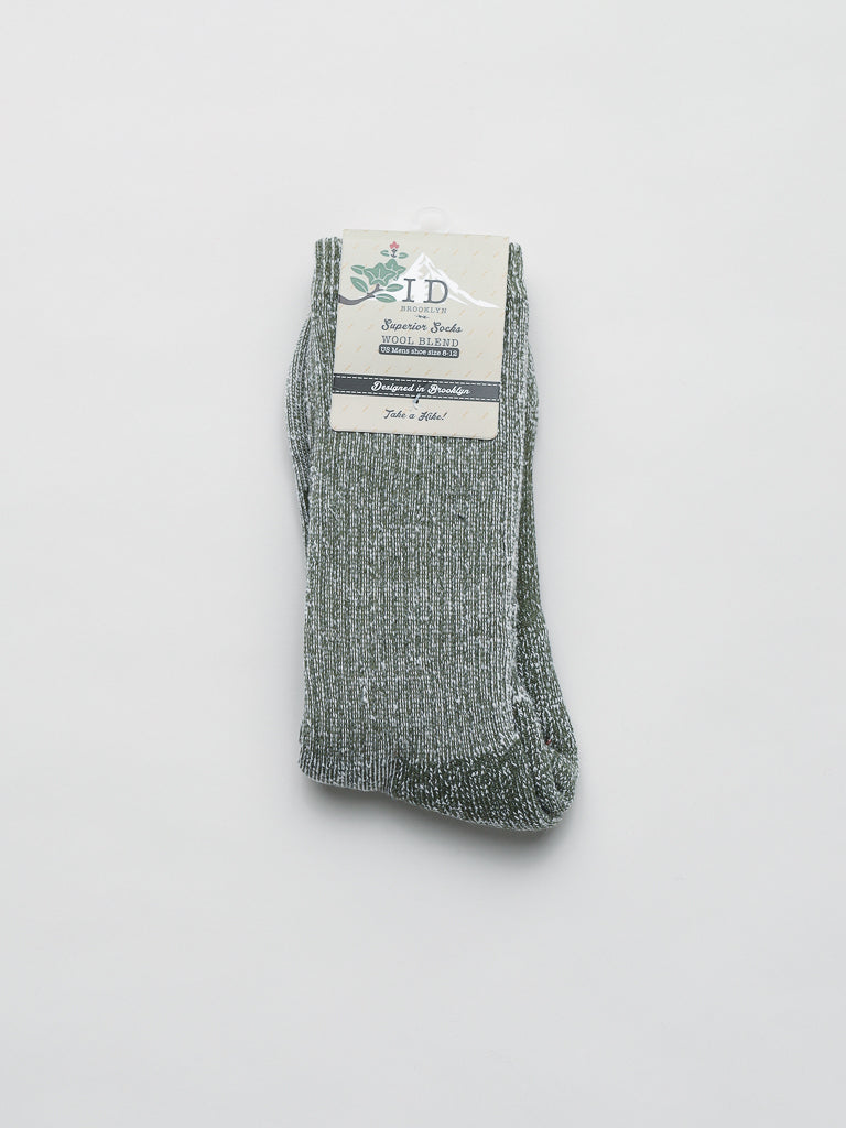 A pair of gray heather Merino Wool Blend Socks by ID Menswear offers textured cold-weather comfort. Neatly folded on a plain white background, they feature a white and green label reading: Signature Socks, Shimmer Style, and Take a pair.