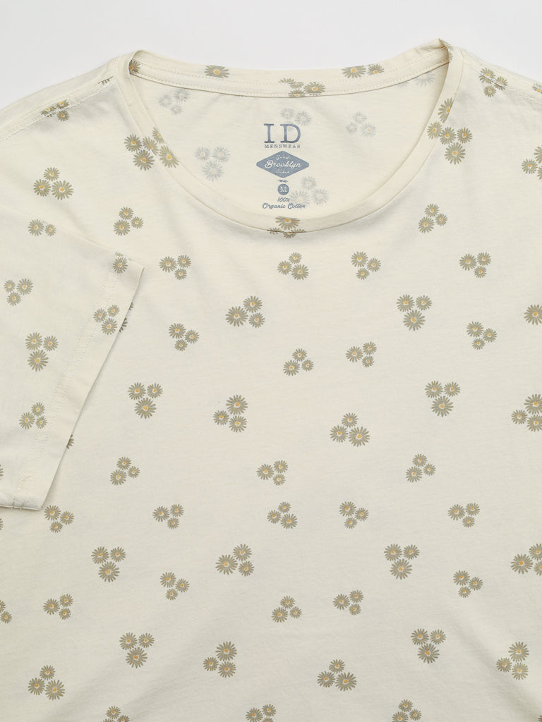 The Heritage Printed Organic Cotton Tee by ID Menswear is a cream-colored, classic-fit T-shirt featuring hand-screen-printed yellow daisies on organic cotton and a round neckline.