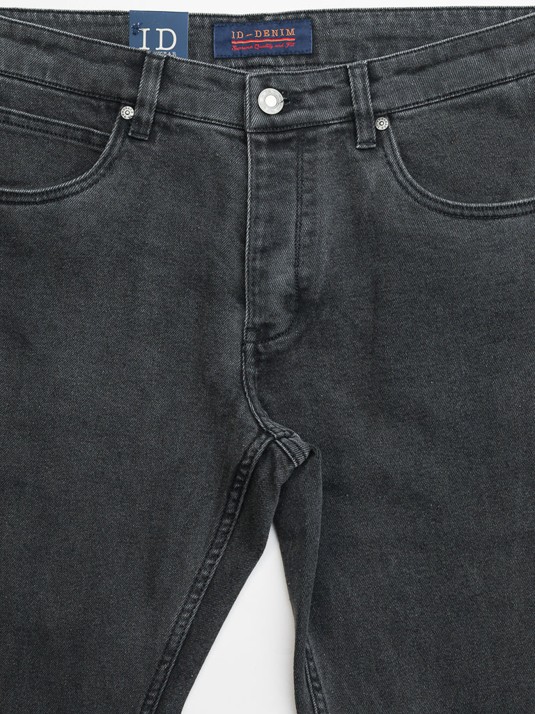 Close-up of ID Menswears Ganbaru Stretch Jean in a dark gray slim-tapered fit, showcasing front pockets and visible fly stitching. A blue label with a red and white logo decorates the waistband. These jeans offer a classic design with slightly textured cotton twill fabric.