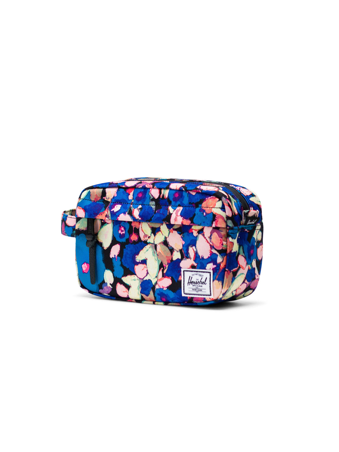 The Herschel Chapter Travel Kit is a rectangular bag with a blue, pink, and green floral pattern, waterproof zipper, side handle, and white brand label—ideal as an organizer or travel kit for your essentials.