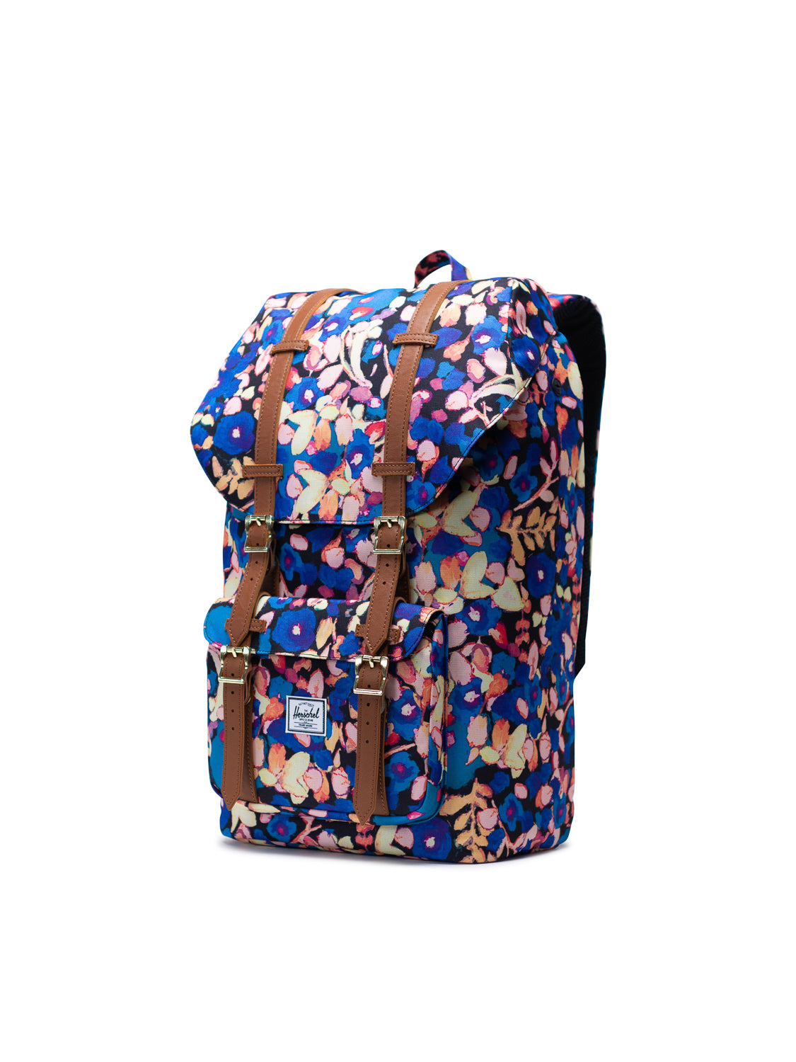 The Herschel Little America Iconic Backpack features a vibrant floral pattern, brown leather straps, front pocket with white label, built-in laptop sleeve, and is shown against a plain white background.