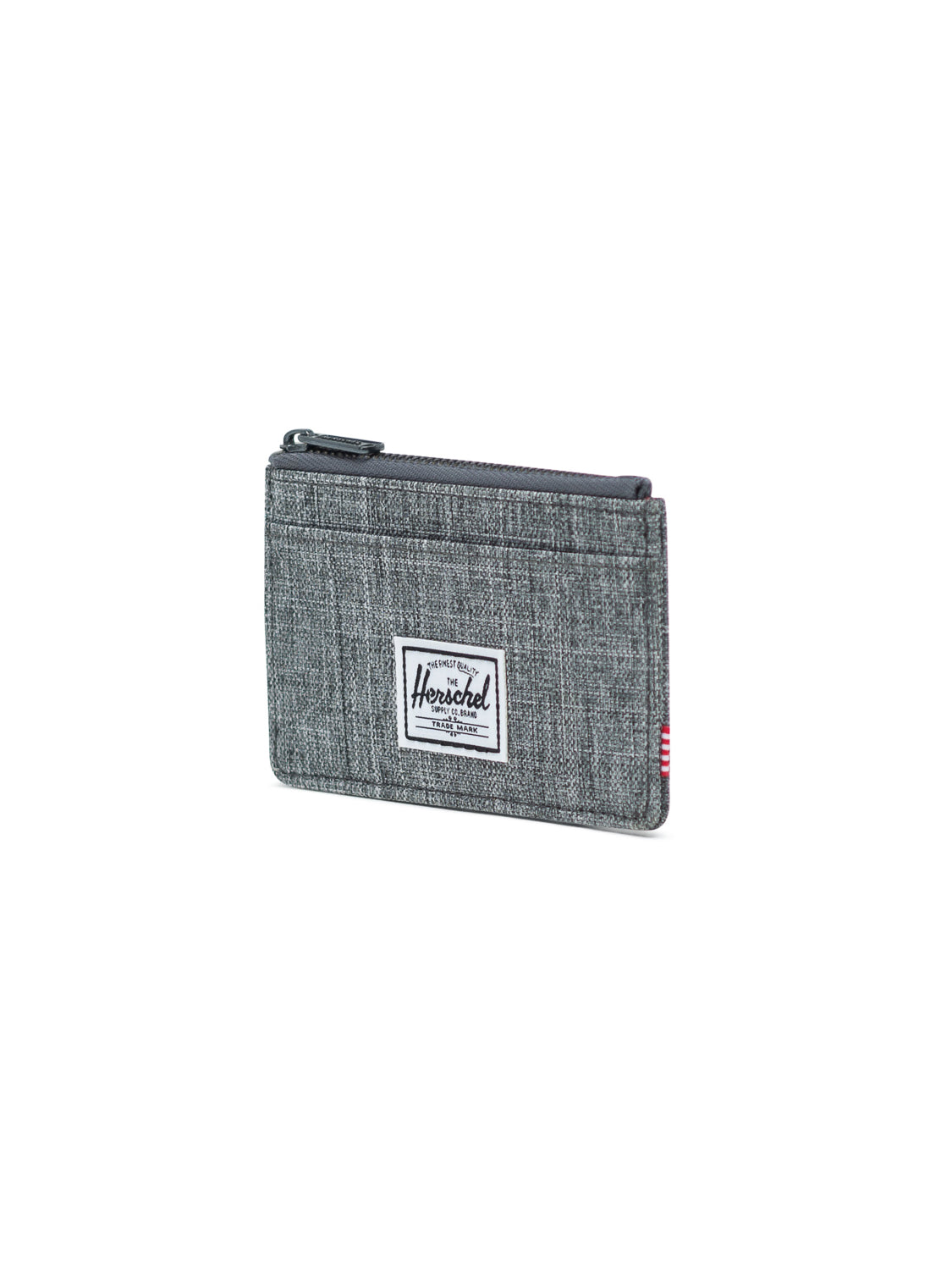 The Herschel Oscar Compact Wallet is a gray fabric zippered RFID-blocking wallet with a white rectangular brand label on the front, displayed against a plain white background.