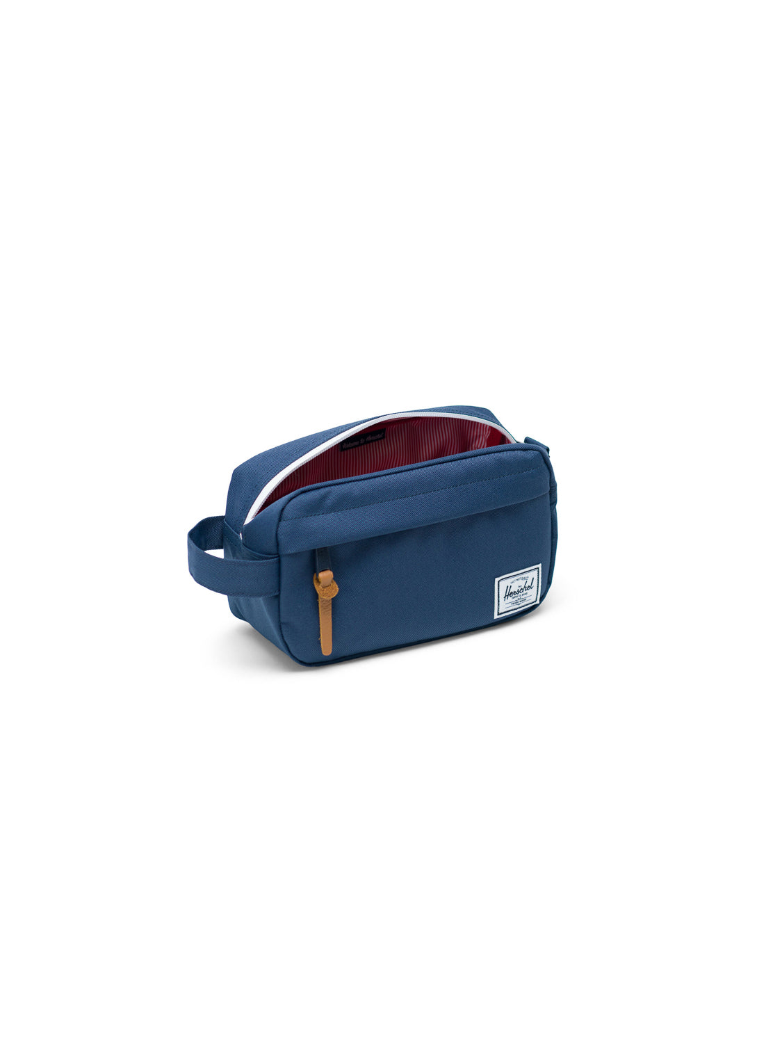 The Herschel Chapter Carry-On Travel Kit is a blue rectangular bag with a side handle, tan zipper pull, white front patch, and an open waterproof zipper showing its red and white striped interior lining.