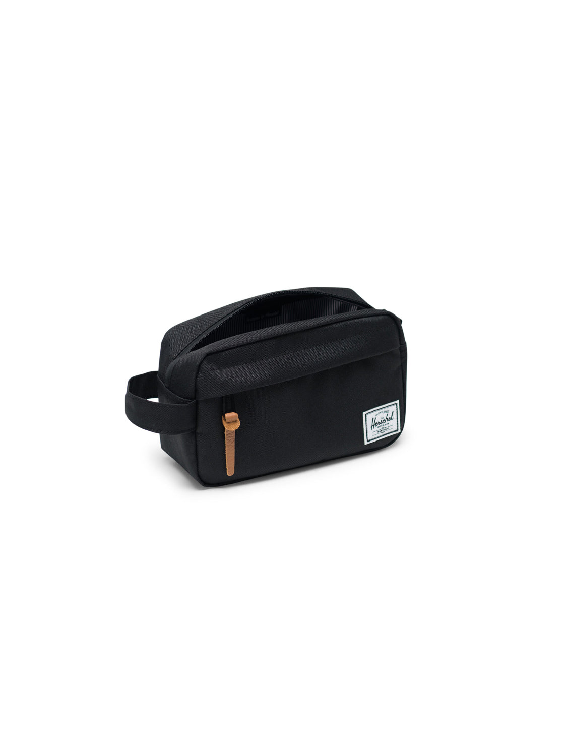 The Herschel Chapter Carry-On Travel Kit is a black, rectangular bag with a side handle, tan zipper pull, waterproof zipper, and a white logo patch on the front, shown on a white background.