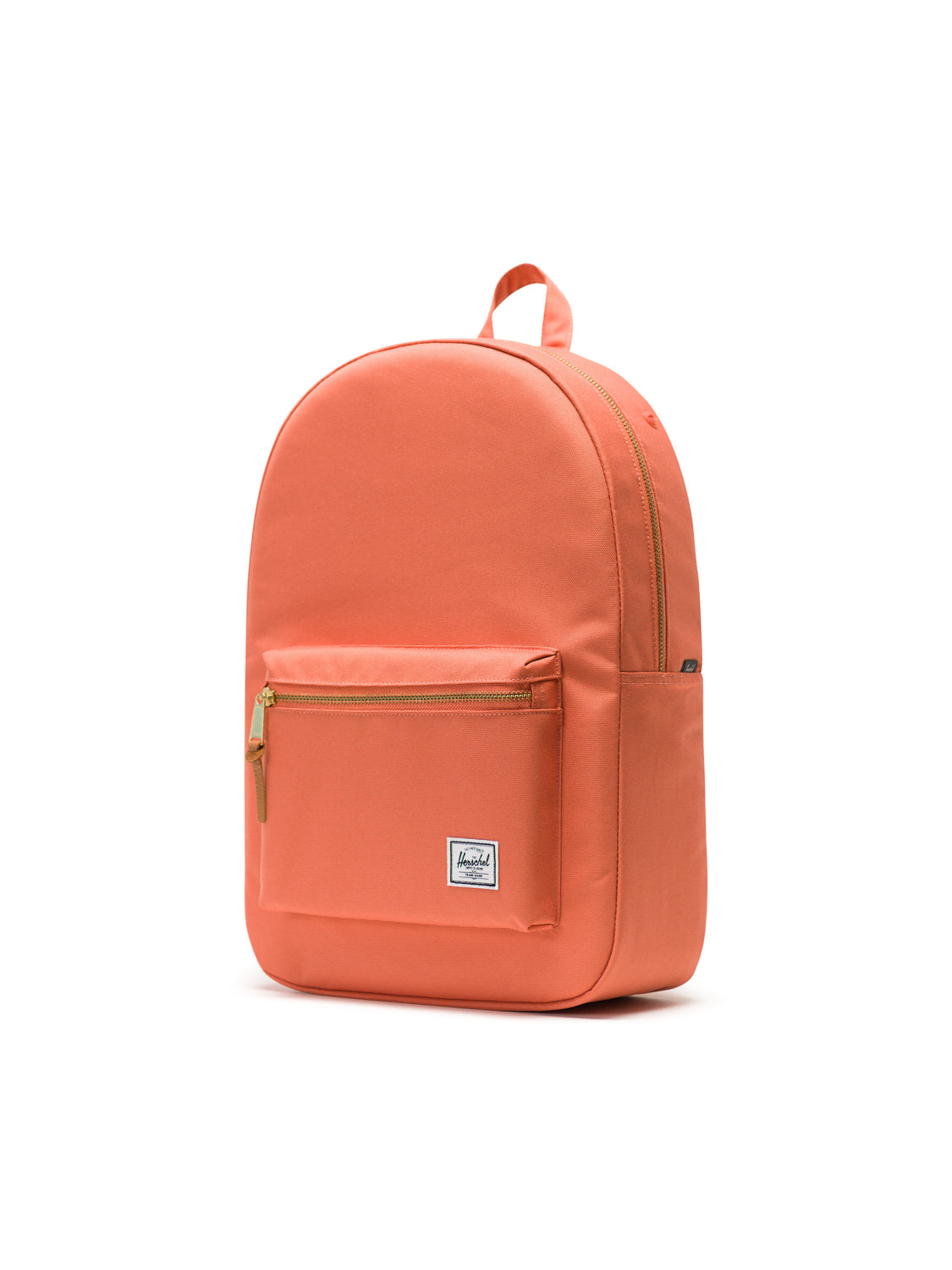 The Herschel Settlement Backpack in coral orange features a front zip pocket, a laptop sleeve, a top handle, and a white rectangular logo patch on the front, shown against a plain white background.