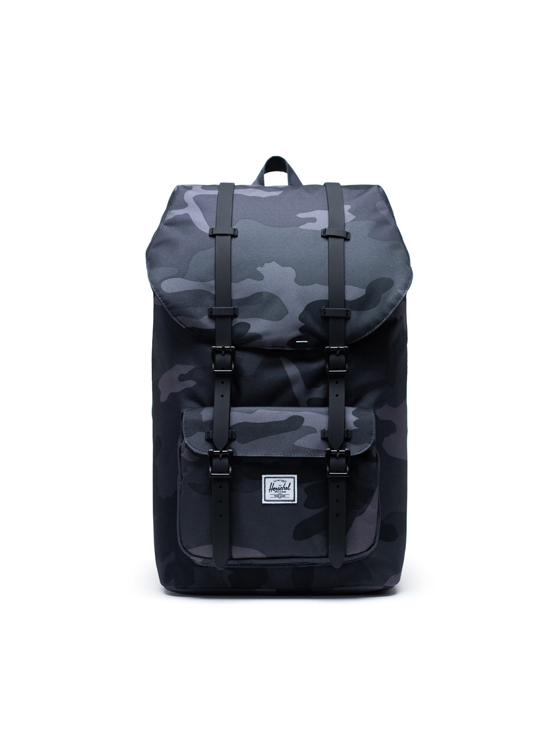 The Herschel Little America Iconic Backpack in black and grey camo features a front pocket, flap closure with two buckle straps, a small white label, and a laptop sleeve. The mountaineering-style bag stands upright against a white background.