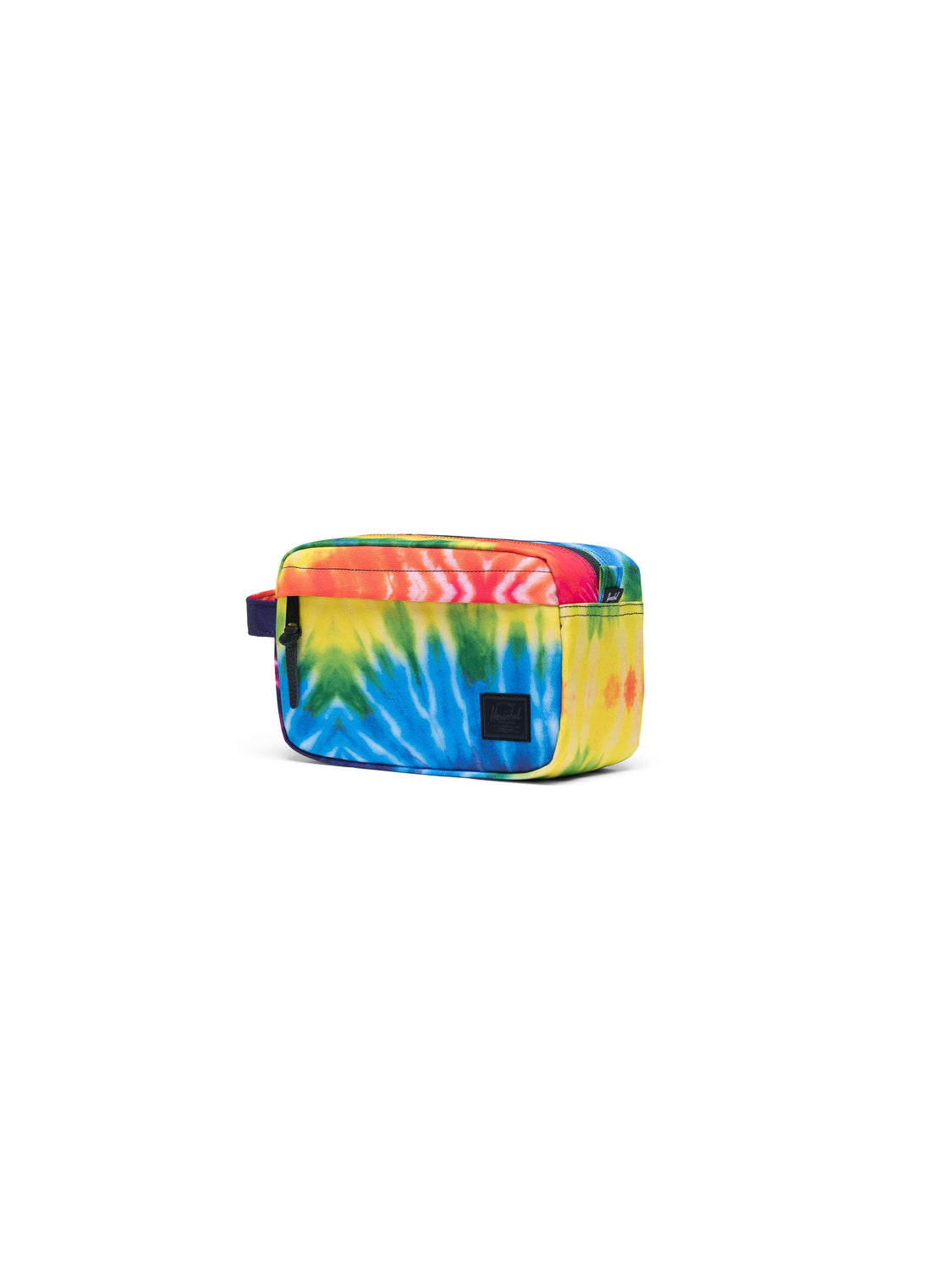The Herschel Chapter Carry-On Travel Kit is a rectangular toiletry bag with a vibrant yellow, blue, green, orange, and red tie-dye pattern, waterproof zipper, side handle, and front black patch—ideal as a compact travel bag.