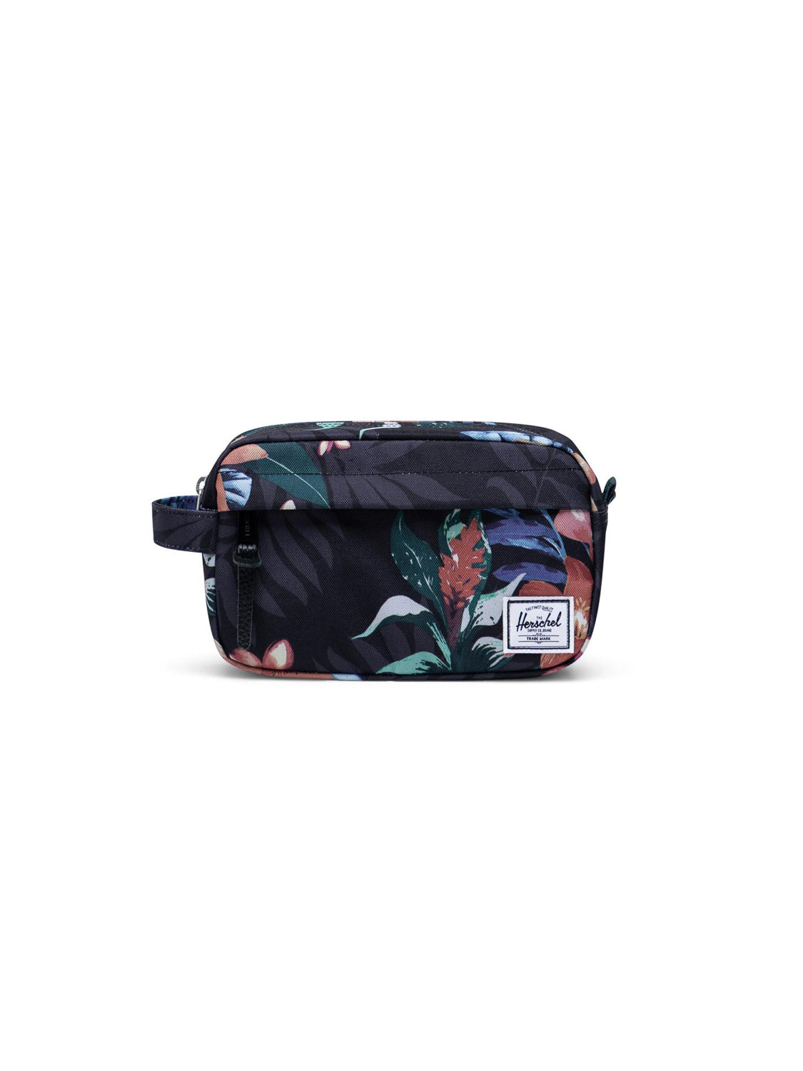The Herschel Chapter Carry-On Travel Kit is a rectangular compact bag with a tropical floral print in dark colors, waterproof zipper, side handle, and a white Herschel logo patch on the front.