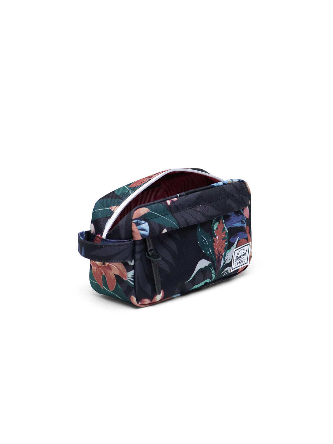 The Herschel Chapter Carry-On Travel Kit is a compact rectangular bag with a colorful tropical leaf pattern, waterproof top zipper, side handle, and white brand patch—ideal for carrying your essentials on any trip.