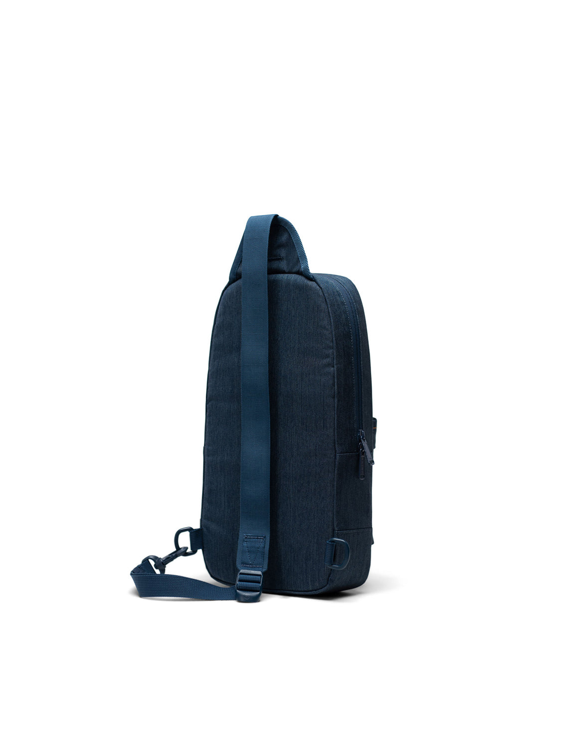 The Herschel Heritage Shoulder Bag, a blue fabric crossbody with a single adjustable strap, stands upright on a white background, angled to show its side and part of the back.