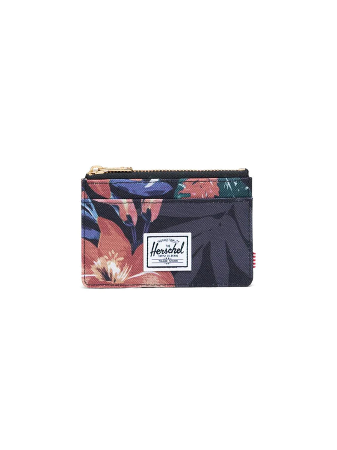 The Herschel Oscar Compact Wallet features a dark background with red, orange, and green tropical floral print, a zippered pocket, card holder sections, and the Herschel logo patch on the front.