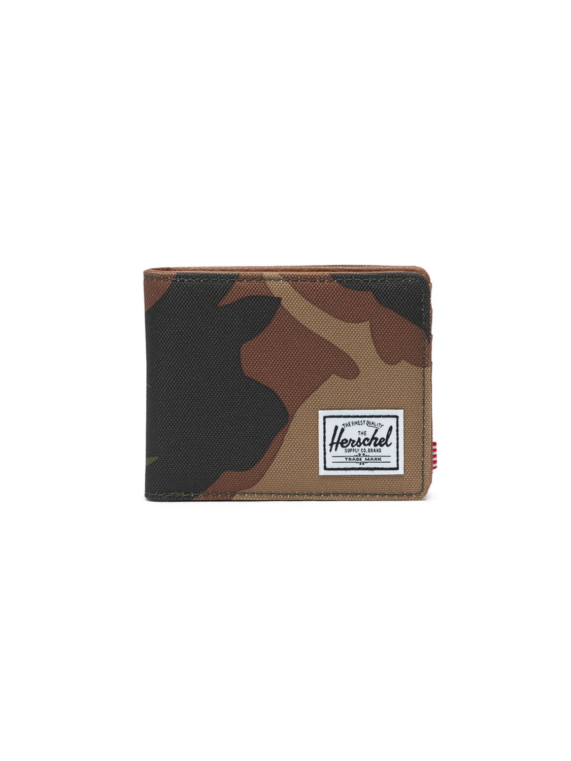 The Herschel Hank Bi-Fold Wallet features a camouflage pattern, RFID blocking, and a white rectangular brand label on the front, shown against a plain white background.