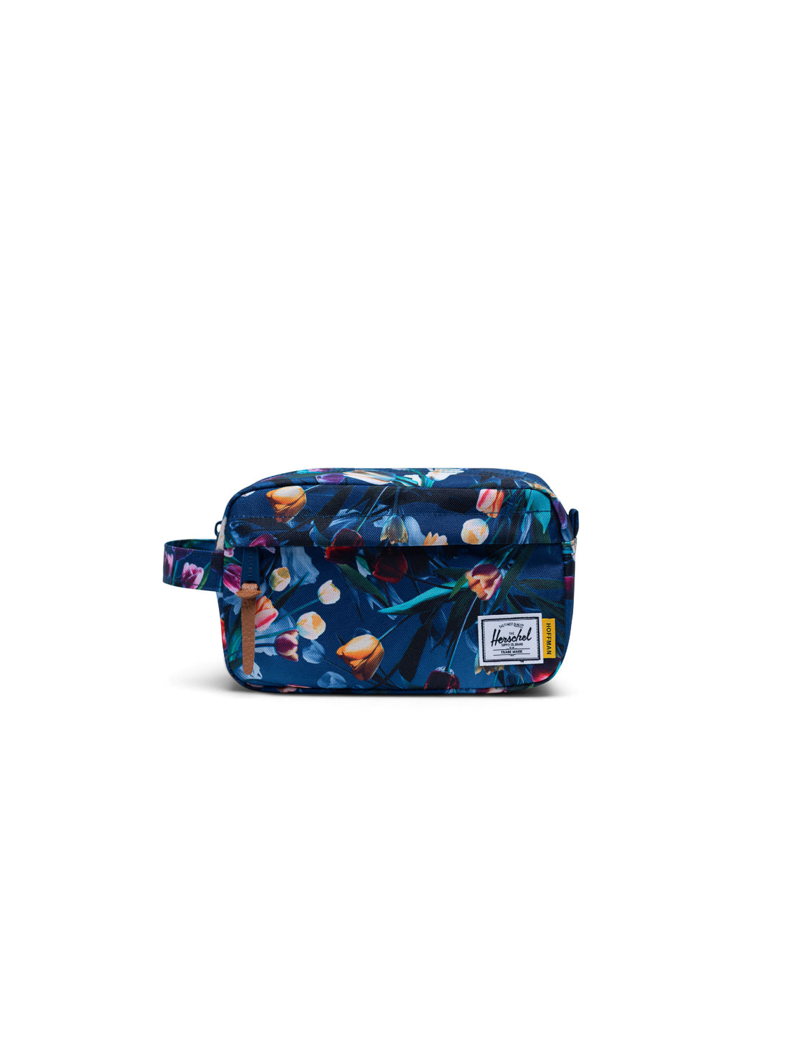 The Herschel Chapter Carry-On Travel Kit is a compact bag with a blue floral print, side handle, front pocket, and a white Herschel logo patch on the lower right. Ideal for keeping essentials organized on any trip.